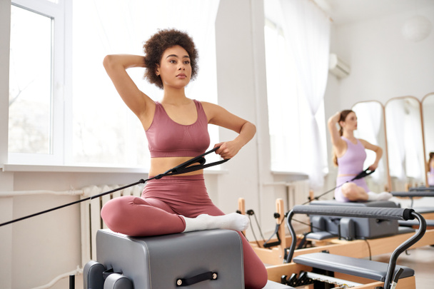 Beautiful women engage in a pilates class, focusing on flexibility and core strength. - Photo, Image
