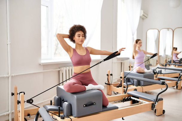 Athletic women engage in a pilates class, focusing on flexibility and core strength. - Photo, Image