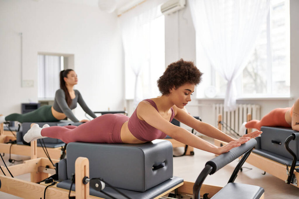 Sporty women practicing pilates in a gym. - Foto, imagen