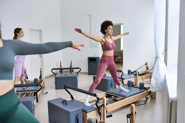 A group of pretty, sporty women engaging in exercises during a pilates lesson at the gym. - Valokuva, kuva