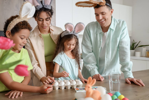 Onnellinen perhe maalaus munat keittiössä pääsiäispäivänä - Valokuva, kuva