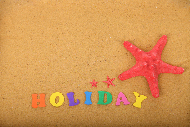 Word "holidays" and starfish - Foto, afbeelding