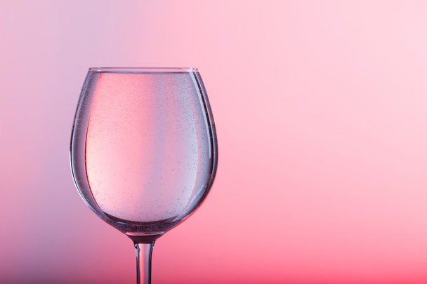 Glass of water on a pink background - Zdjęcie, obraz