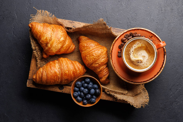 Cappuccino coffee and fresh croissants on stone table. Flat lay - Photo, Image
