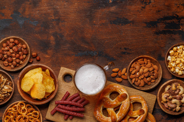 Assorted Beer Stands: chips, nuts, pretzels. Diverse Options for Refreshment flat lay with copy space - Photo, Image