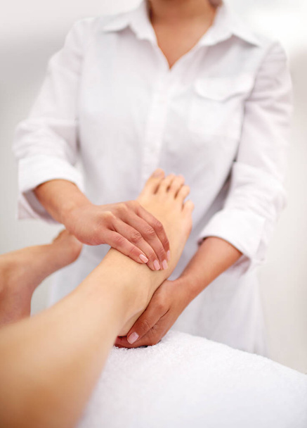 Foot, hands and massage with spa for self care, beauty and skincare at luxury resort for peace and wellness. Pedicure, cosmetics and people for feet muscle with healing for treatment and relief. - Photo, Image