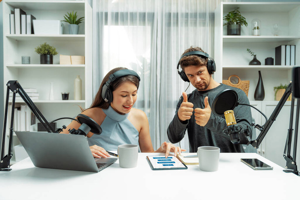 Host channel broadcasters discussing together, making advice for problem in live streaming with listeners surrounded sets of live streaming on radio talking show at comfy modern workplace. Postulate. - Photo, Image