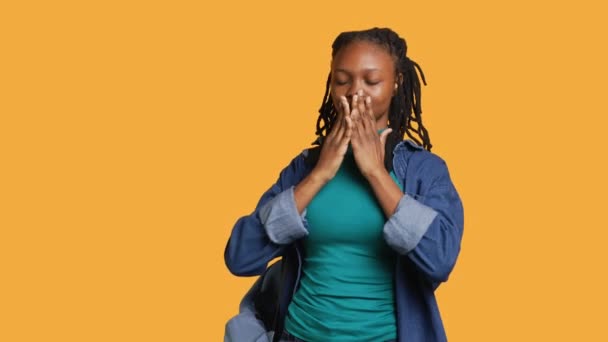 African american woman covering eyes, ears and mouth with hands, imitating the three wise monkeys. Girl doing do not see, do not hear and do not speak gesturing concept, studio background, camera A - Footage, Video