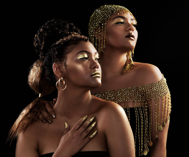 Gold, vision and black women with jewelry for fashion, beauty and rich with crown for luxury on dark background. African queen, glow and pride for culture, wealth and royalty by studio backdrop. - Photo, Image