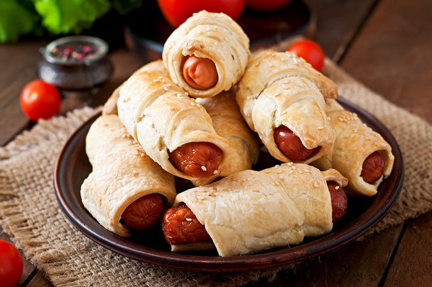 Sausage in the dough sprinkled with sesame seeds - Photo, Image