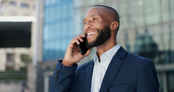 Happy, businessman and city with phone call for conversation, communication or chat outside building. Outdoor, young man or employee with smile on mobile smartphone for friendly business discussion. - Photo, Image