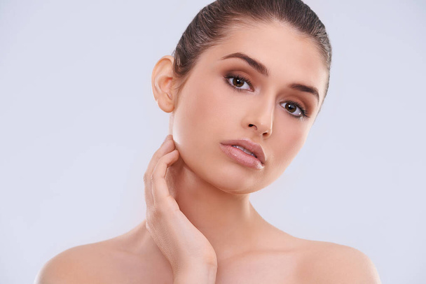 Dermatology, beauty and portrait for woman in studio for skincare and wellness with makeup for clean, clear and smooth. Model or young person with lipstick for shine and face for hygiene and fresh. - Photo, Image