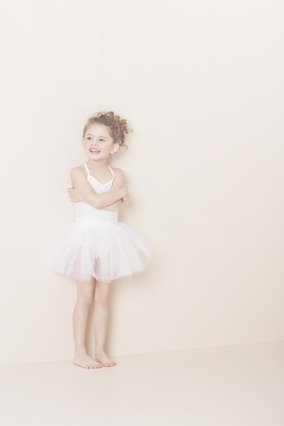 Young ballerina standing in studio - 写真・画像