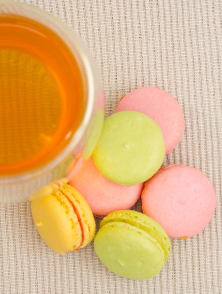 Delicate French cookies and glass cup of tea - Photo, Image