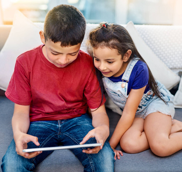 Tablet, kids and siblings on sofa for play, online and esports for entertainment. Technology, streaming and internet for video while bonding in lounge, gaming and digital for model app on touchscreen. - Photo, Image