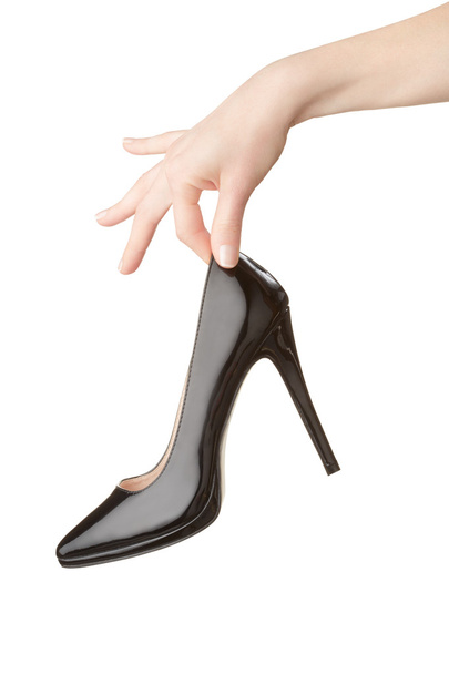 Woman hand holding black high heel shoe on white - Foto, Bild