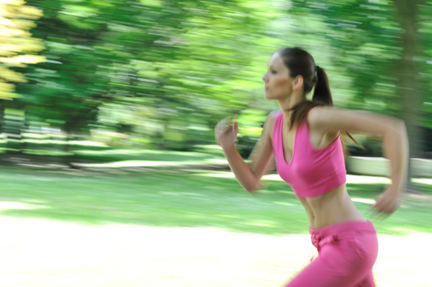 Young woman running outdoor - motion blurr - Фото, изображение