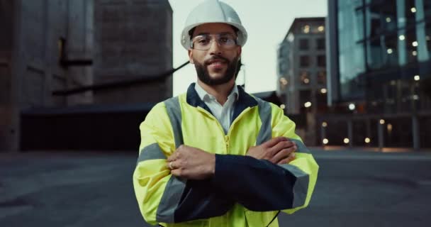 Face, engineering or happy man in city with arms crossed or smile for architecture or building. Construction site labor, night project and portrait of proud builder, confident worker and contractor. - Footage, Video
