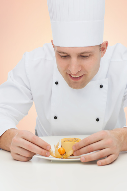 happy male chef cook decorating dessert - Photo, Image