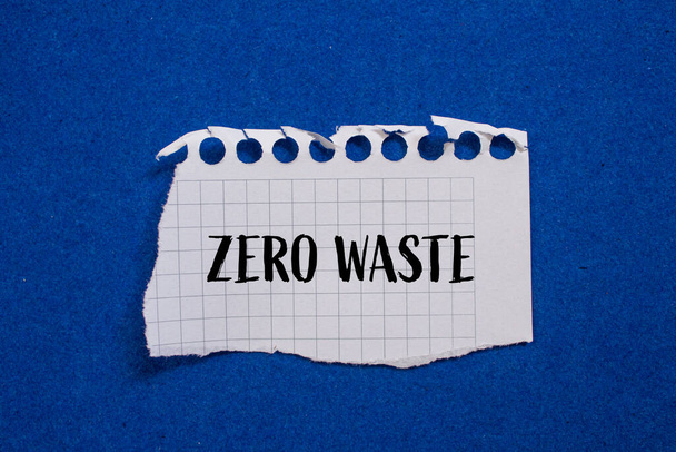 Zero waste written on ripped paper with blue background. Concept - Photo, Image