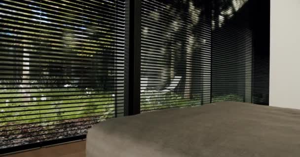 Stylish interior featuring modern blinds with a serene view of greenery. Perfect blend of urban and natural elements. Modern Interior Design with Elegant Blinds and Natural View - Footage, Video
