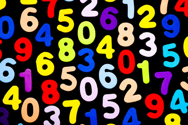 Brightly coloured numbers on black background - Foto, afbeelding