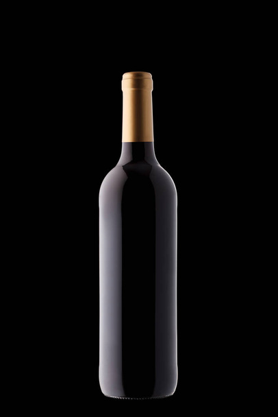 Bottle of wine with beautiful highlights on a black background close-up - Photo, Image