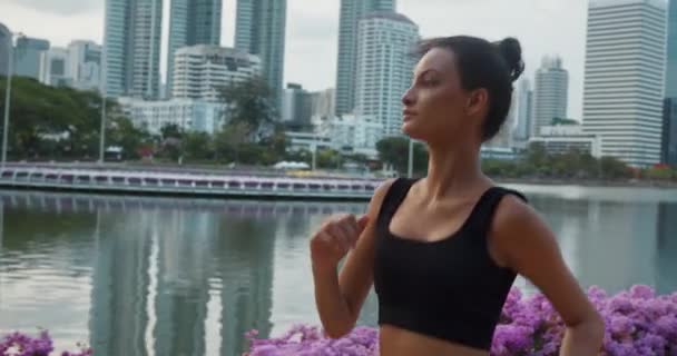 Amidst urban hustle woman athlete finds solace in park running gracefully healthy lifestyle. Woman dedication healthy lifestyle running every day with summer warmth and refreshing healthy breeze - Footage, Video