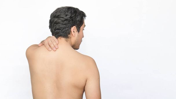 A Shirtless man with neck pain, white background, space for text on the right. - Photo, Image
