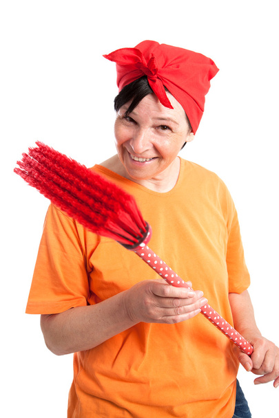 Middle aged woman with dotted broom - Photo, Image
