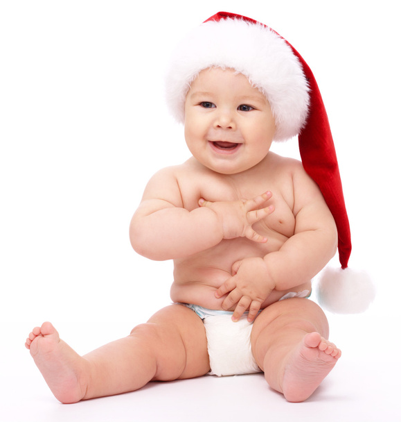 Little child wearing red Christmas cap - Foto, imagen