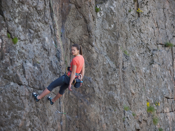 Una giovane ragazza impegnata nell'arrampicata su roccia
. - Foto, immagini