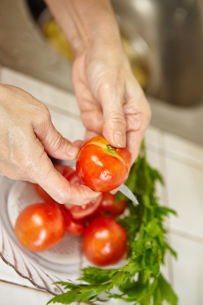 Cutting tomato for making chicken stew - Photo, image