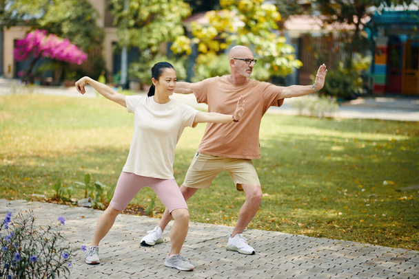 Mature diverse couple working out outdoors in the morning - Photo, Image