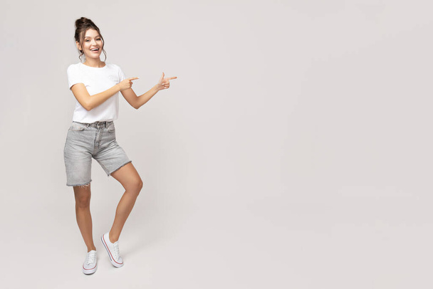 Attraente giovane ragazza in posa su uno sfondo bianco - Foto, immagini