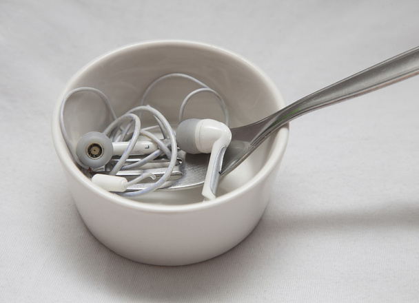 Earplugs with fork in little bowl - Photo, Image