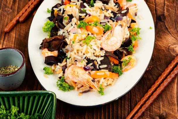 Traditional Chinese food, fried rice with shrimp and mushrooms. - Photo, Image