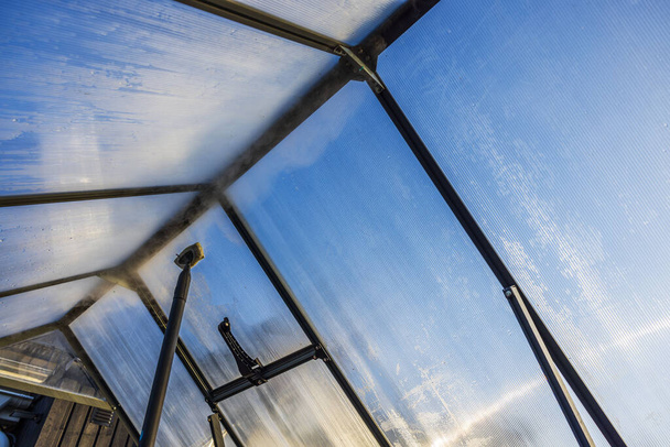 Close-up view of a steam cleaner being used to clean the interior of a greenhouse, preparing it for the new planting season. Sweden. - Photo, Image