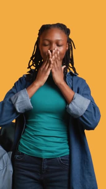 Vertical video African american woman covering eyes, ears and mouth with hands, imitating the three wise monkeys. Girl doing do not see, do not hear and do not speak gesturing concept, studio - Footage, Video