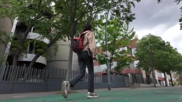 Studente donna con zaino e laptop a piedi in città - Filmati, video