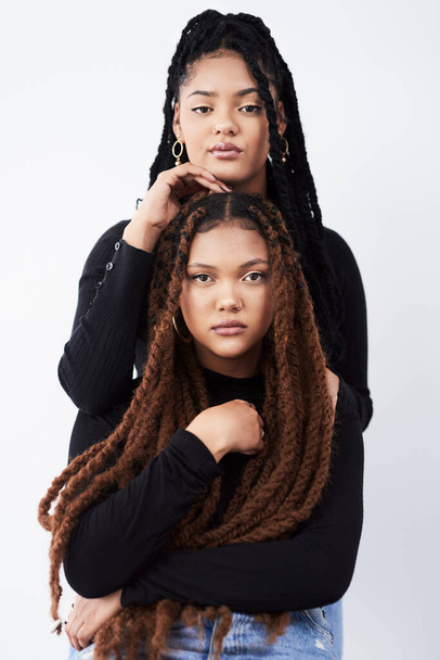 Lesbian couple, portrait and fashion in studio with pride for style inspiration, jeans and together. Serious, lgbt and black people for support with women, relationship and dreadlocks with clothes. - Photo, Image