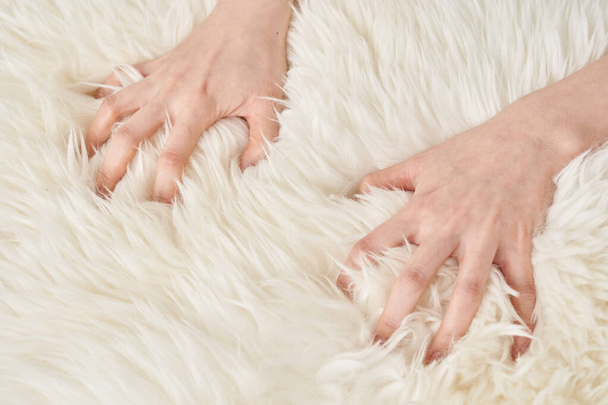 A woman's hand touches the fluffy fabric - Photo, Image