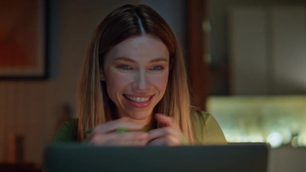 Κλείσιμο freelancer videocalling σκοτεινό διαμέρισμα. Πορτρέτο του χαμογελαστού γυναίκα ακούγοντας σε απευθείας σύνδεση πορεία με συνέδριο laptop στο σπίτι νύχτα. Ευτυχής τηλεχειριζόμενος εργαζόμενος μιλώντας στο βίντεο κλήση υπολογιστή αργά το βράδυ. - Πλάνα, βίντεο