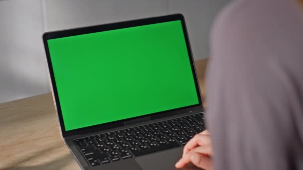 Estudiante irreconocible estudiando ordenador portátil de pantalla verde sentado en casa de cerca. Mujer manos tocando maqueta ordenador pantalla táctil navegar por Internet. Desconocido freelancer trabajando remotamente en el dispositivo de croma key. - Metraje, vídeo