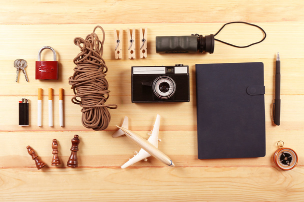 Travel gear on wooden table, top view - Foto, imagen