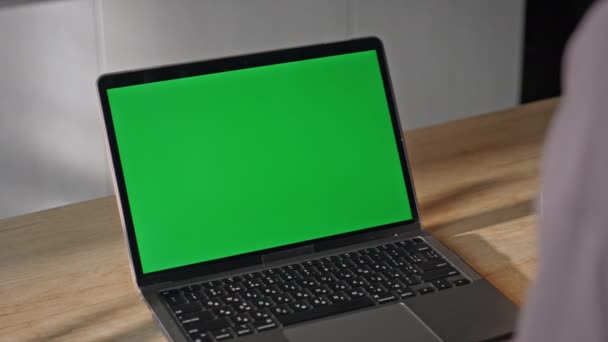 Remote employee looking mockup laptop having video conference at home table close up. Unrecognizable woman working online at green screen computer in apartment. Unknown girl using chroma key gadget. - Footage, Video