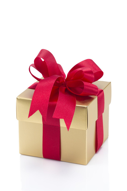 Beautiful gold present box with red bow and ribbons - Foto, Imagen