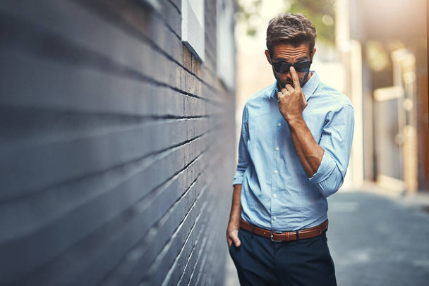 Business, portrait and man in street with sunglasses, confidence and office fashion for opportunity. Brick wall, urban professional and businessman with trendy style, pride and startup career in city. - Photo, Image