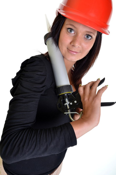 Woman with caulking gun - Foto, afbeelding