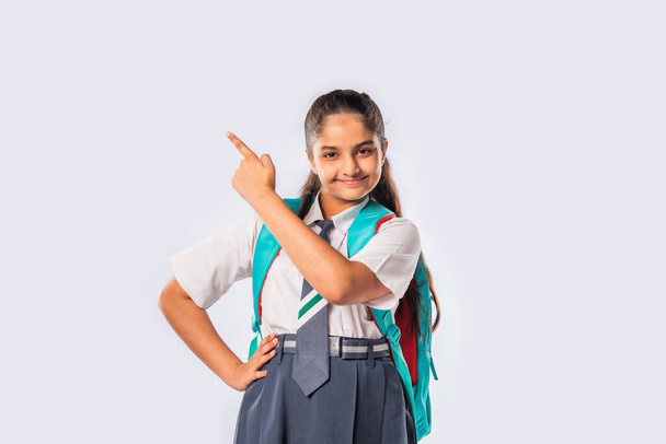 Indian asian schoolgirl wears school uniform and standing with backpack - Photo, Image